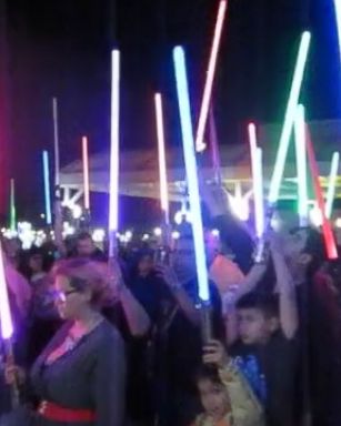 Star Wars fans at movie theaters in Texas held a vigil for Carrie Fisher by raising lightsabers into the air in a powerful tribute to the late actress.